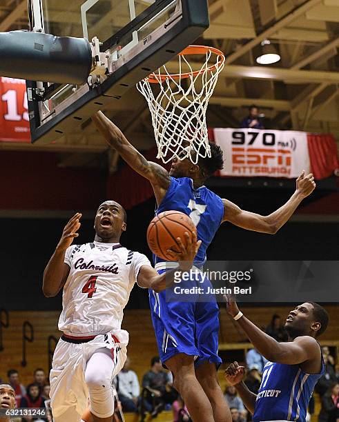 Clive Allen of the Robert Morris Colonials goes to the basket against Mustafa Jones of the Central Connecticut State Blue Devils in the second half...