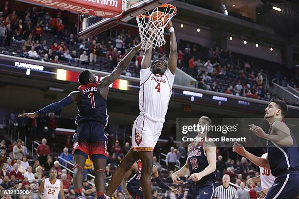 Chimezie Metu of the USC Trojans goes to the basket against Rawle Alkins of the Arizona Wildcats during NCAA Pac12 conference college basketball game...