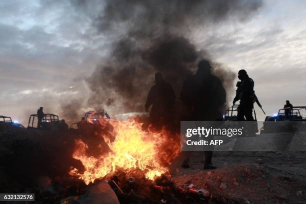 Federal Police stand near a fire outside of Federal Prison Cefereso number 9 where Joaquin Guzman Loera aka "El Chapo Guzman" was jailed before being...