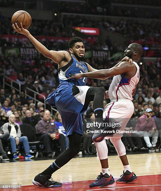 Karl-Anthony Towns of the Minnesota Timberwolves is defended by Raymond Felton of the Los Angeles Clippers during the first half half of the...