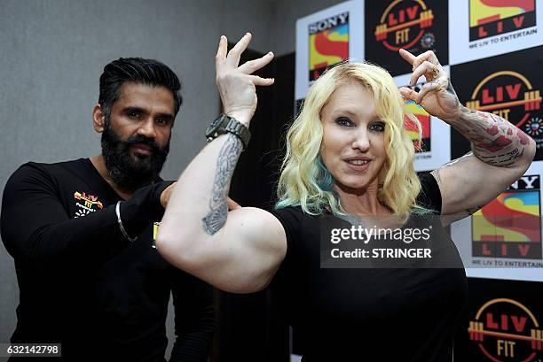 Indian Bollywood actor, Suniel Shetty and Swedish bodybuilder, personal trainer, celebrity trainer, nutritionist Marika Johansson pose during the...