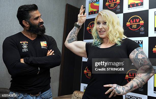 Indian Bollywood actor, Suniel Shetty and Swedish bodybuilder, personal trainer, celebrity trainer, nutritionist Marika Johansson pose during the...