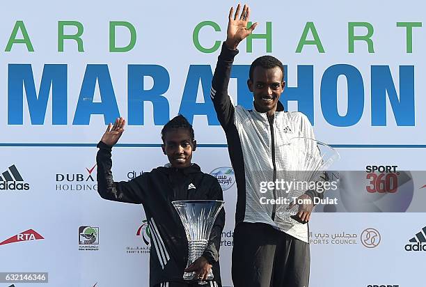 Winner of Elite Men's race Tamirat Tola and winner of Elite Women's race Worknesh Degefa of Ethiopia pose for photos after Standard Chartered Dubai...