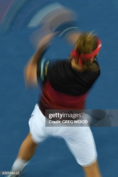 Slow shutter speed exposure shows Slovakia's Lukas Lacko hitting a return against Japan's Kei Nishikori during their men's singles third round match...