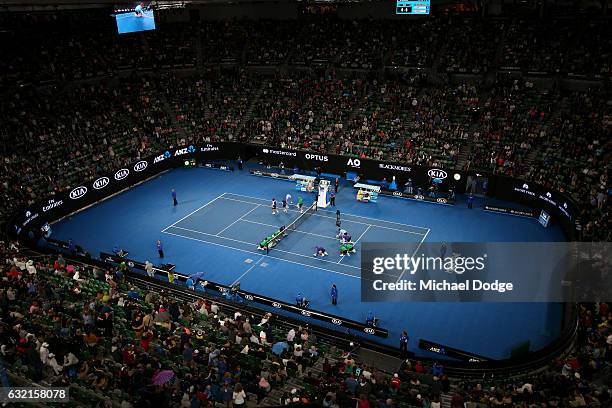 Ball kids dry the court as rain start to fall during the third round match between Mona Barthel of Germany and Ashleigh Barty of Australia on day...