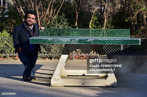 President of the French Association of Small People Othmane El Jamali poses next to a table tennis table at a park in Paris on January 6, 2017. Words...