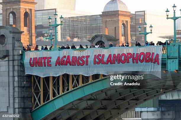 Anti Donald Trump demonstrators drop a banner, reading "Unite Against Islamophobia" over Southwark Bridge in London, England, U.K on January 20,...