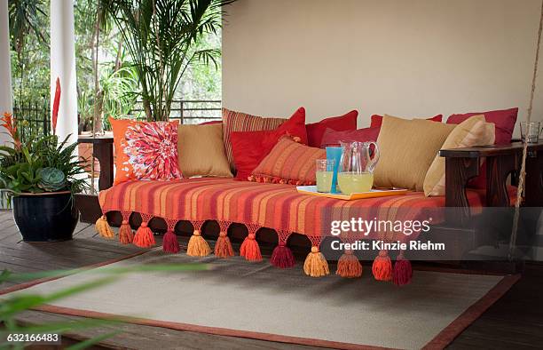 cushion covered swing seat on porch - tassel stock pictures, royalty-free photos & images