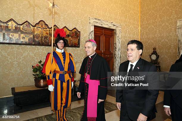 President of Paraguay Horacio Manuel Cartes Jara flanked by the Prefect of the Pontifical House Georg Ganswein as they arrive at the Apostolic Palace...