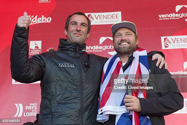 British yachtsman Alex Thomson celebrates finising 2nd in the Vendee Globe solo non stop around the world yacht race with race winner Armel Le...