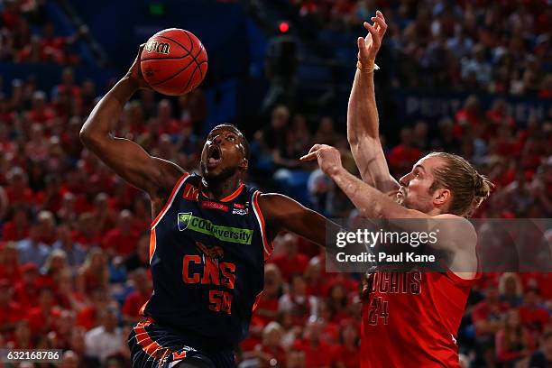 Tony Mitchell of the Taipans lays up against Jesse Wagstaff of the Wildcats during the round 16 NBL match between the Perth Wildcats and the Cairns...