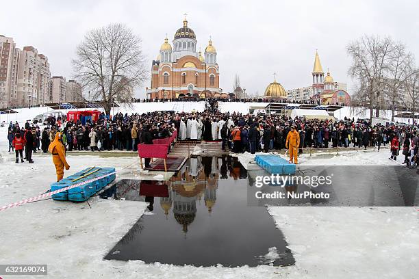 Ukrainian Orthodox believers bathe in cross-alike ice-holes on Dnipro river as they celebrate Epiphany in Kiev, Ukraine, on January 19, 2017.