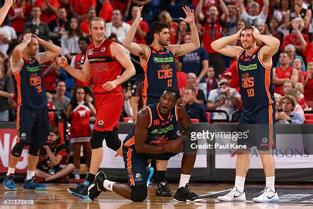 Jesse Wagstaff of the Wildcats celebrates a call as Mark Worthington, Stephen Weigh, Nnanna Egwu and Mitch McCarron of the Taipans react after Bryce...