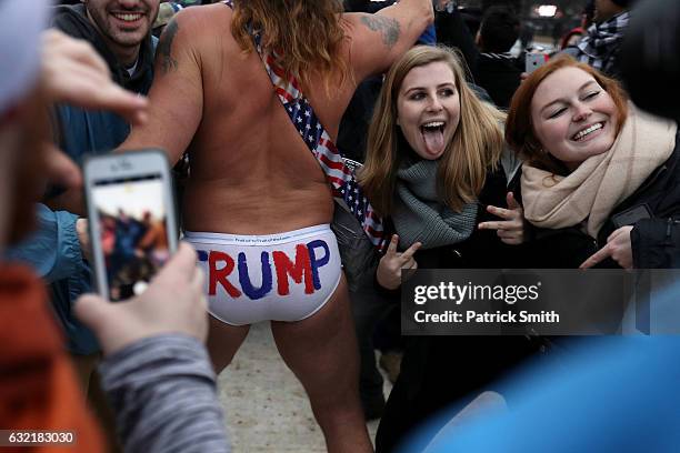 People gather on the National Mall prior to the inauguration on January 20, 2017 in Washington, DC. Donald Trump is being sworn in as the 45th...