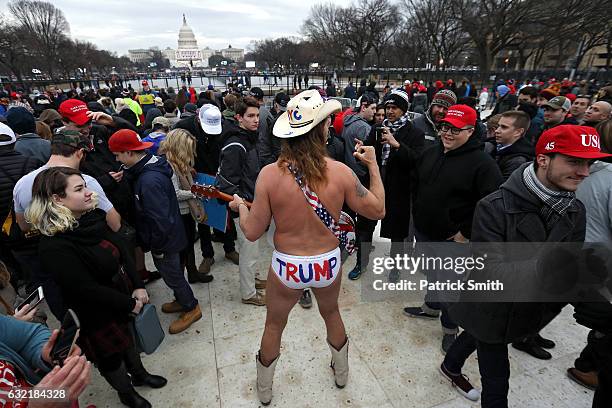 Cowboy dressed in underwear plays guitar as people gather on the National Mall prior to the presidential inauguration on January 20, 2017 in...