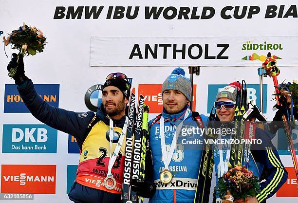 First placed Anton Shipulin of Russia poses with second placed Martin Fourcade of France and third placed Sergey Semenov of Ukraine during the podium...