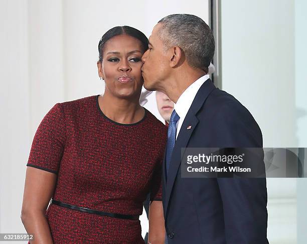 President Barack Obama gives a kiss to his wife first lady Michelle Obama before the arrival of President-elect Donald Trump and his wife Melania...