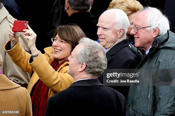 Sen. Amy Klobuchar takes a selfie with Sen. Chris Van Hollen , Sen. John McCain and Sen. Bernie Sanders on the West Front of the U.S. Capitol on...