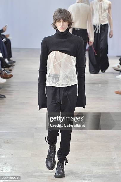Model walks the runway at the Ann Demeulemeester Autumn Winter 2017 fashion show during Paris Menswear Fashion Week on January 20, 2017 in Paris,...