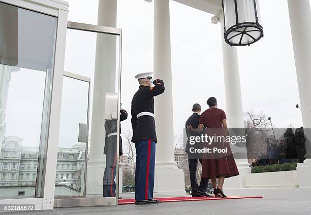 President Barack Obama and First Lady Michelle Obama watch as President-elect Donald Trump's motorcade arrives at the White House prior to his...