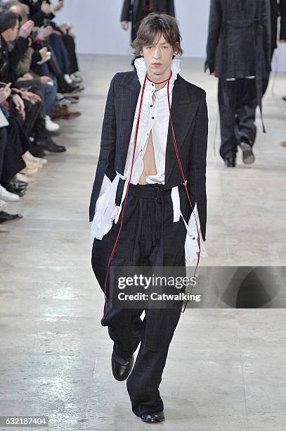 Model walks the runway at the Ann Demeulemeester Autumn Winter 2017 fashion show during Paris Menswear Fashion Week on January 20, 2017 in Paris,...