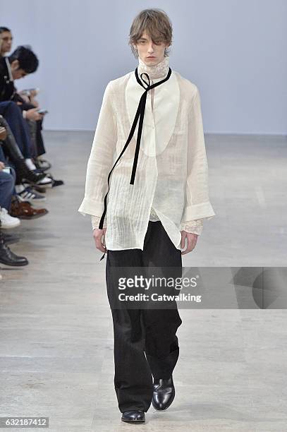 Model walks the runway at the Ann Demeulemeester Autumn Winter 2017 fashion show during Paris Menswear Fashion Week on January 20, 2017 in Paris,...