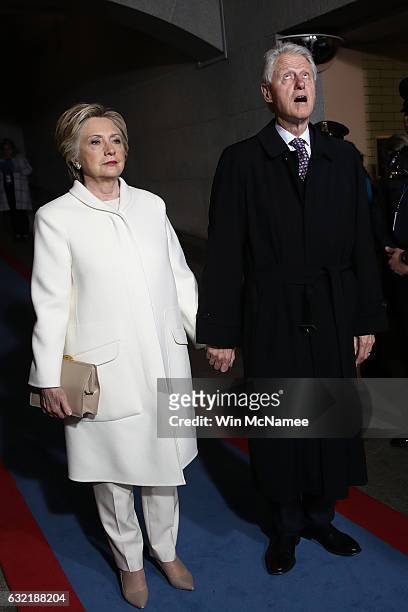 Former Democratic presidential nominee Hillary Clinton and former President Bill Clinton arrive on the West Front of the U.S. Capitol on January 20,...