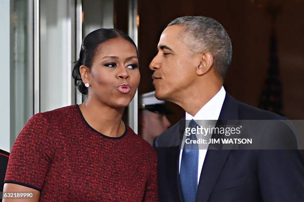 President Barack Obama and First Lady Michelle Obama kiss as they prepare to greet President-elect Donald Trump and his wife Melania to the White...