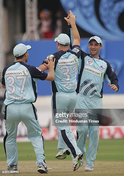Cricket - Champions League T20 - CLT20 - David Warner of the Blues celebrates with her teammate after throwing down the stumps to run out Arul...
