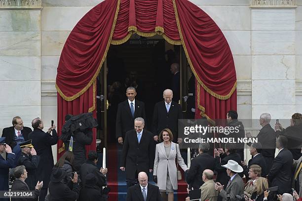 President Barack Obama and Vice-President Joe Biden arrive with New York Senator John Chuck Schumer Representative Nancy Pelosi on the platform at...