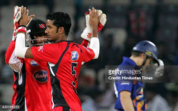 Cricket - Champions League T20 - CLT20 - Sherwin Ganga of Trinidad is congratulated by team mate Denesh Ramdin on the wicket of Morne van Wyk of...