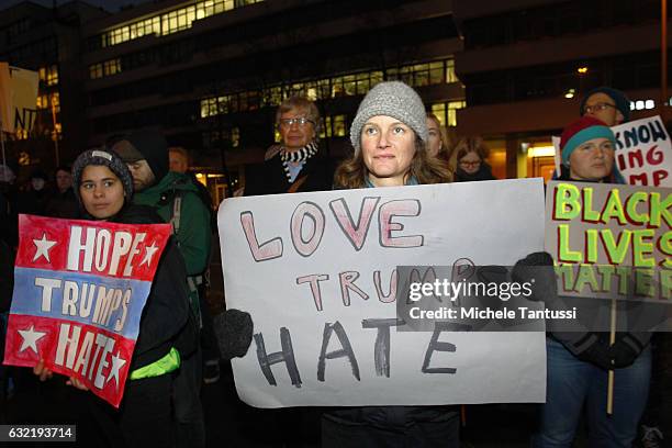 Protesters standing in front of the Headquarters of the far right party AFD or Alternative fuel Deutschland, hold placard with anti Trump Slogans as...