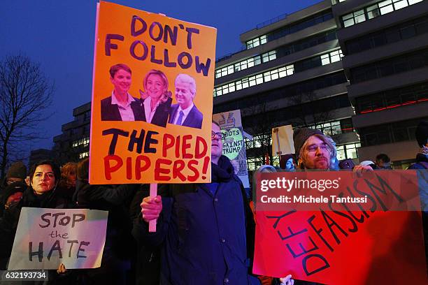 Protesters standing in front of the Headquarters of the far right party AFD or Alternative fuel Deutschland, hold placard with anti Trump Slogans as...