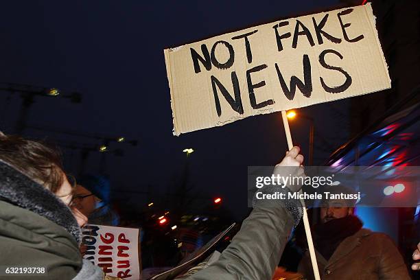 Protesters standing in front of the Headquarters of the far right party AFD or Alternative fuel Deutschland, hold placard with anti Trump Slogans as...