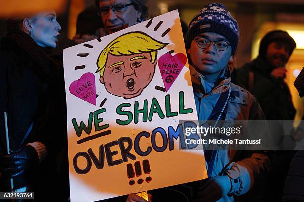 Protesters standing in front of the Headquarters of the far right party AFD or Alternative fuel Deutschland, hold placard with anti Trump Slogans as...