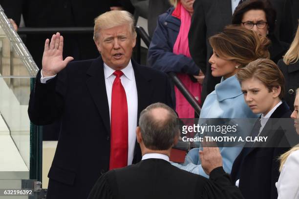 Donald Trump is sworn in as the 45th US president by Supreme Court Chief Justice John Roberts in front of the Capitol in Washington on January 20,...
