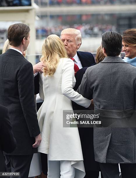 President Donald Trump kisses his daughter Ivanka after being sworn in during the Presidential Inauguration at the US Capitol in Washington, DC, on...