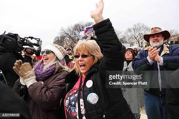 President Donald Trump supporters react on the National Mall to the inauguration of Donald Trump on January 20, 2017 in Washington, DC. Washington...