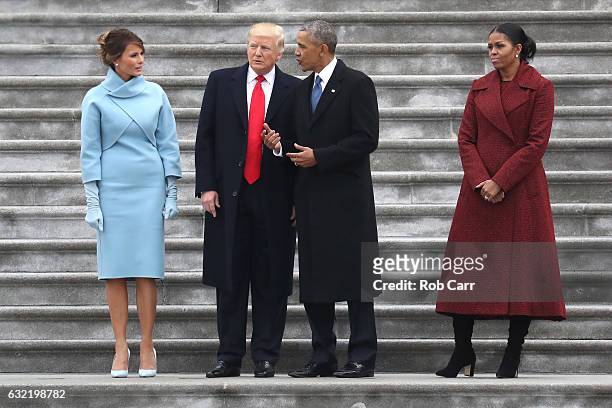 President Donald Trump and former president Barack Obama stand on the steps of the U.S. Capitol with First Lady Melania Trump and Michelle Obamal on...