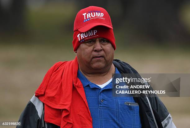 Supporter of US President-elect Donald Trump walks on the National Mall in Washington, DC, on January 20 before the swearing-in ceremony. Donald...