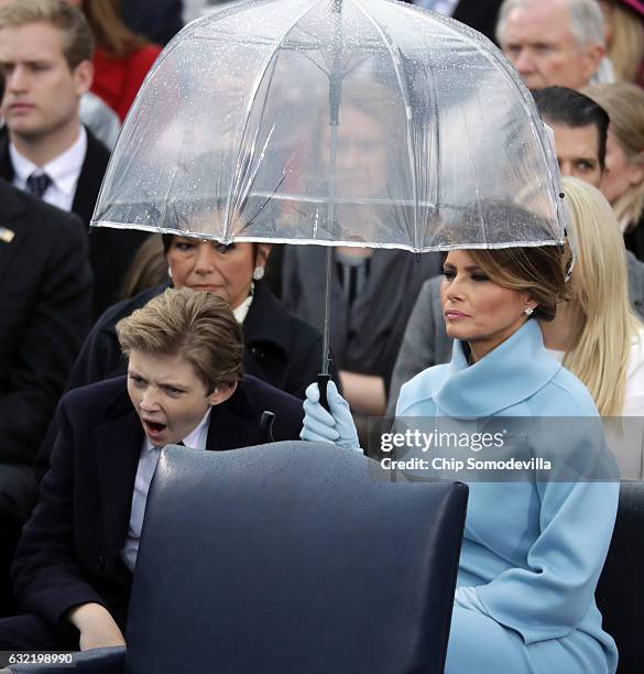 First lady Melania Trump and her son Barron Trump watch U.S. President Donald Trump's inaugural address on the West Front of the U.S. Capitol on...