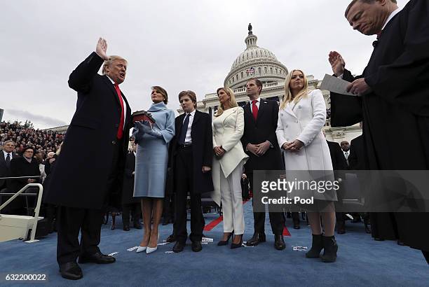 President Donald Trump takes the oath of office as his wife Melania holds the bible and his children Barron, Ivanka, Eric and Tiffany watch as U.S....