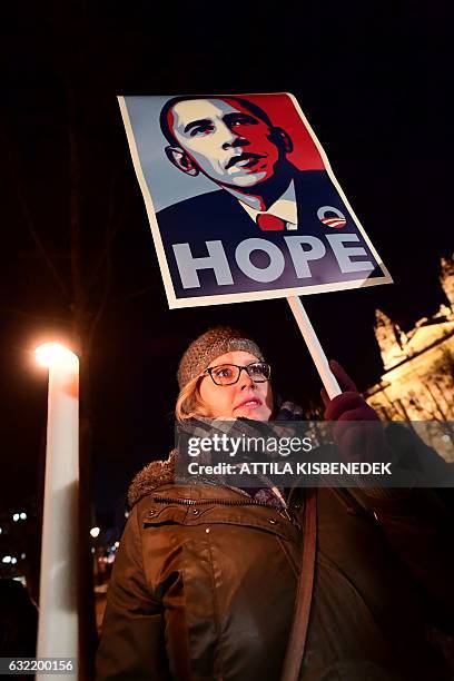 Woman holds a poster featuring outgoing US president Barack Obama during an anti Donald Trump protest on the day of his inauguration as US President...