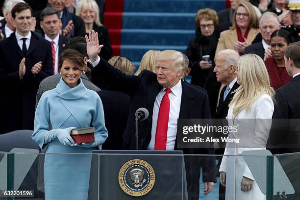 President Donald Trump waves after he is sworn into office on the West Front of the U.S. Capitol on January 20, 2017 in Washington, DC. In today's...