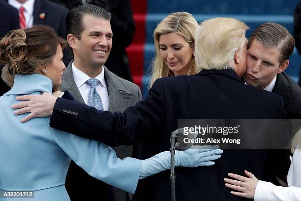 President Donald Trump kisses his son Eric Trump after his inauguration on the West Front of the U.S. Capitol on January 20, 2017 in Washington, DC....