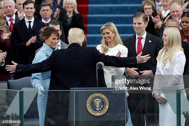 President Donald Trump reaches out to embrace son Barron Trump as First Lady Melania Trump, Ivanka Trump , Eric Trump and Tiffany Trump look on after...