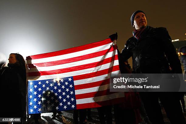 Protesters hold the national US Flag upside-down as they take part in a gathering to voice their opposition to new U.S. President Donald Trump on the...