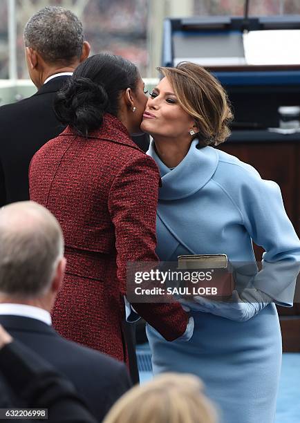 First Lady Melania Trump kisses former First Lady Michelle Obama at the Presidential Inauguration of Donald Trump at the US Capitol in Washington,...