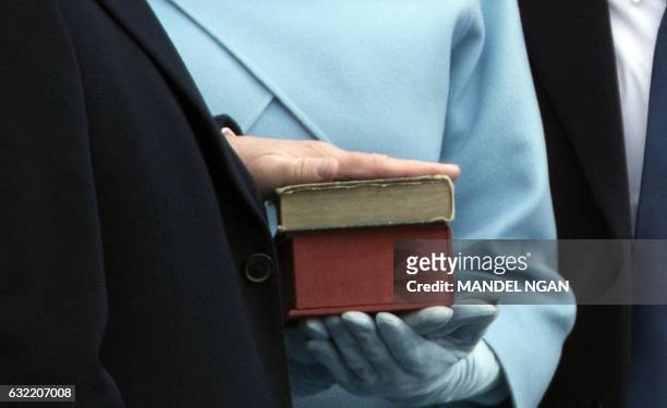 President-elect Donald Trump places his hand on a bible as he takes the oath of office as the next president of the United States on January 20, 2017...