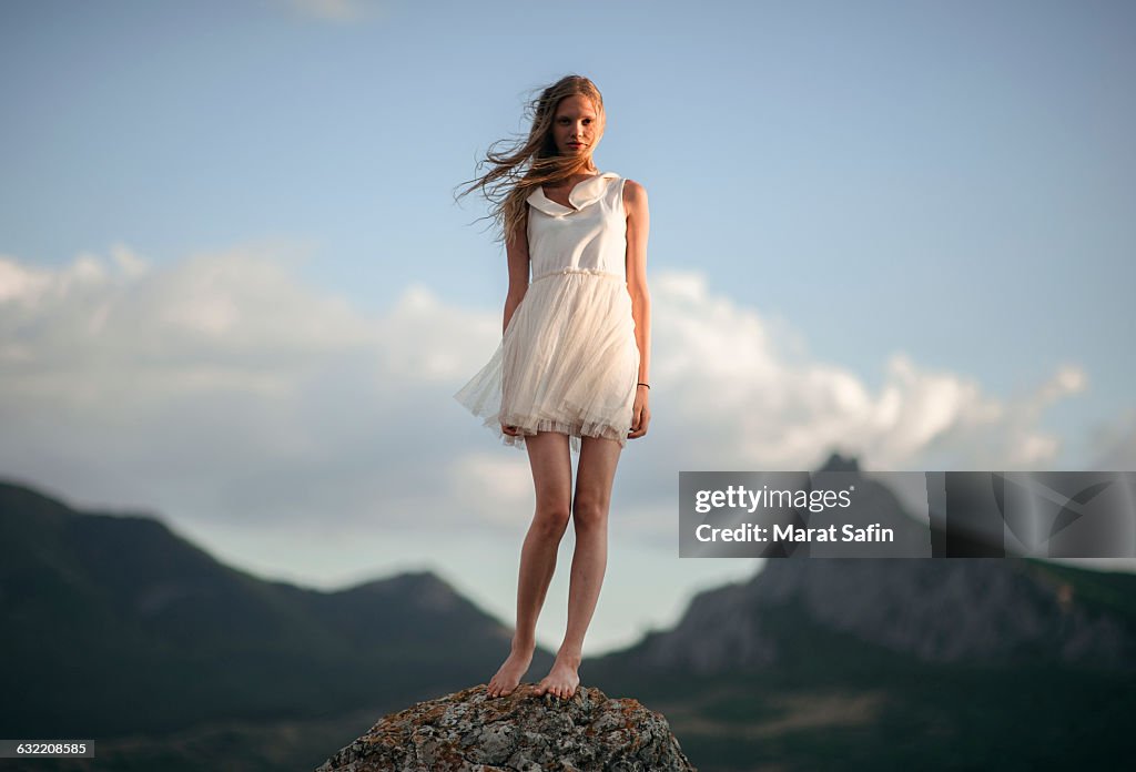 Caucasian woman standing on remote hilltop